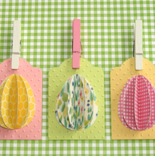 Celebrate Easter by making these simple DIY egg tags using your favorite paper. Fun idea to add to your Easter baskets or treats to make them extra special. #craftedliving #easter #easterdiy #diycrafts