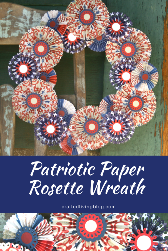 Make a beautiful DIY Patriotic Paper Rosette Wreath to hang on your door. Perfect for Memorial Day or the 4th of July or any patriotic celebration. Simply follow this step by step tutorial. #craftedliving #diycrafts #wreaths #wreathtutorial